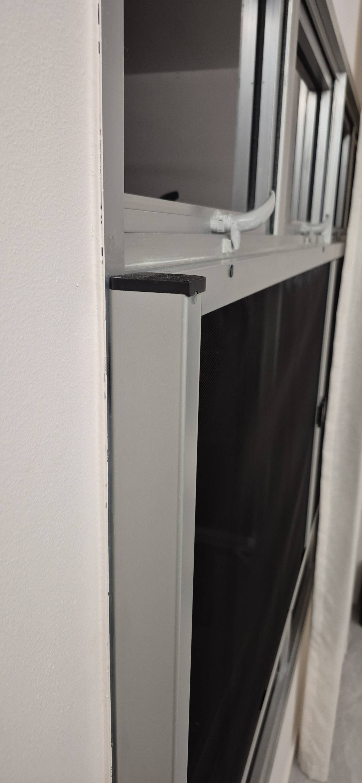 Side-profile view of the sleek retractable mesh housing integrated into a window frame.