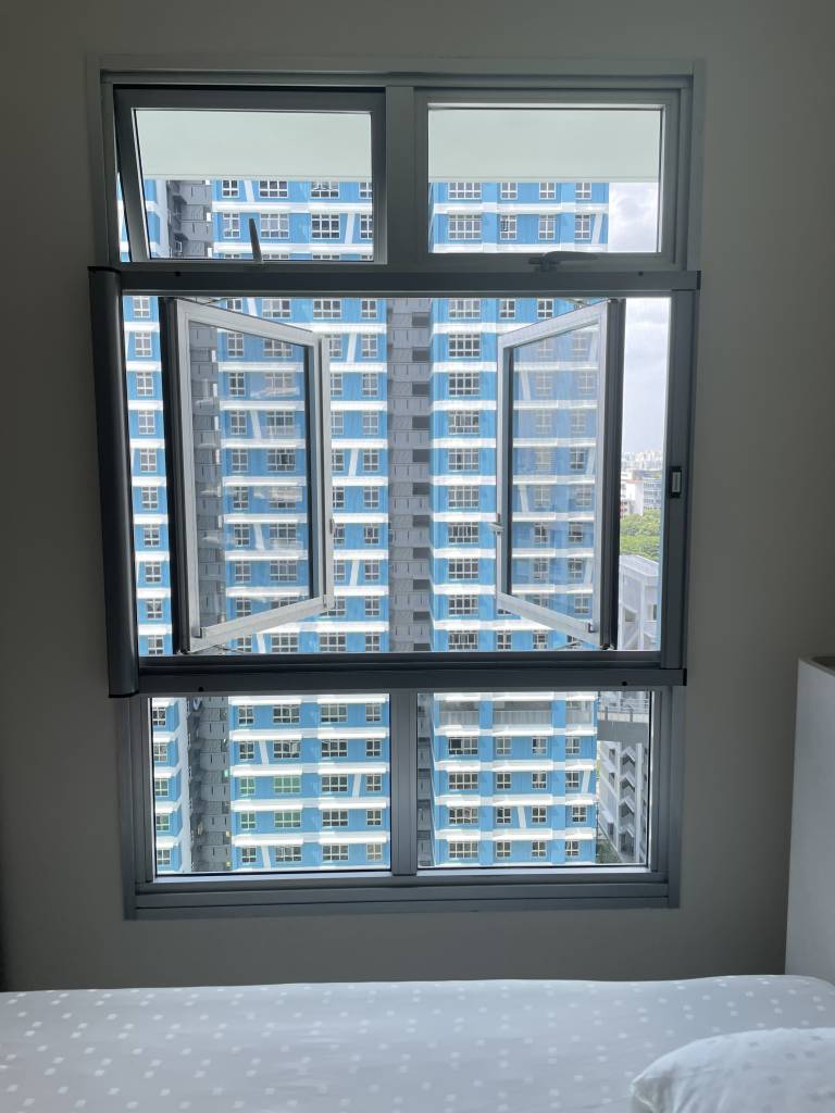 Full-length retractable mesh screen by Dinomesh on a high-rise apartment window.